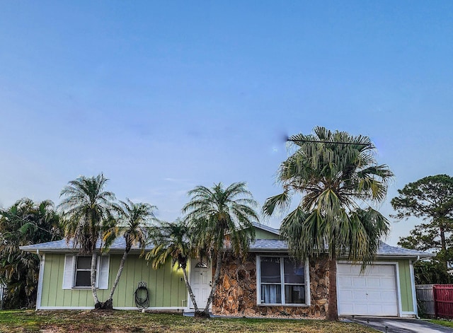 1831 SW Notre Dame Ave, Port Saint Lucie, FL 34953 - view of front facade with a garage
