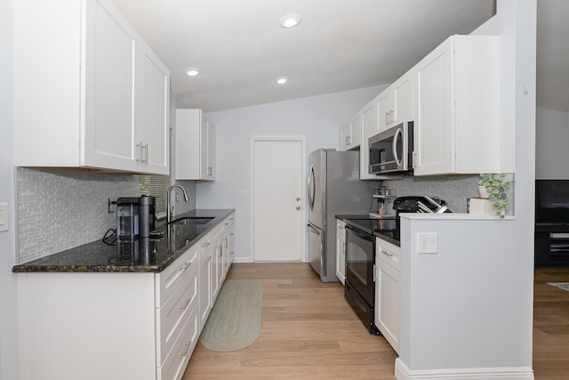 1831 SW Notre Dame Ave, Port Saint Lucie, FL 34953 - kitchen with appliances with stainless steel finishes, a sink, light wood-type flooring, white cabinets, and recessed lighting