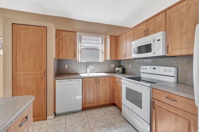 kitchen featuring a sink, white appliances, decorative backsplash, light countertops, and light tile patterned floors