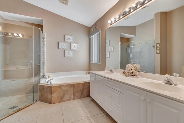 bathroom featuring a stall shower, a garden tub, a sink, and vaulted ceiling
