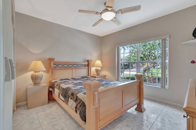 bedroom featuring baseboards, a ceiling fan, and light tile patterned floors
