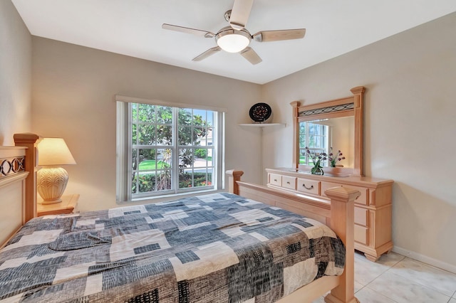 bedroom with light tile patterned flooring, baseboards, a ceiling fan, and multiple windows
