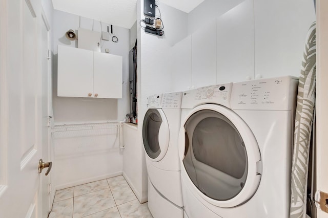 clothes washing area with washer and clothes dryer and cabinet space