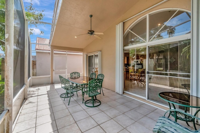 sunroom / solarium with a ceiling fan and outdoor dining space