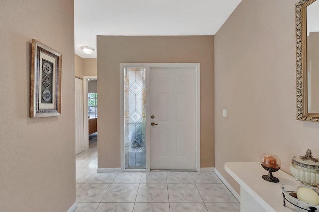 entrance foyer featuring light tile patterned floors and baseboards