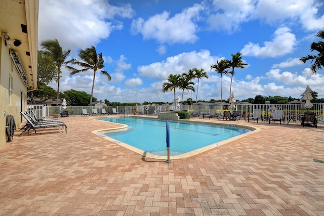 community pool featuring a patio and fence