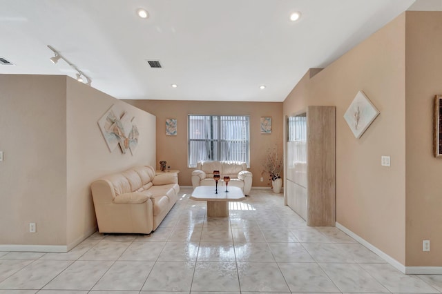 living room featuring rail lighting, lofted ceiling, visible vents, and recessed lighting