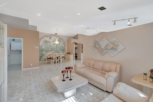 living room with arched walkways and visible vents