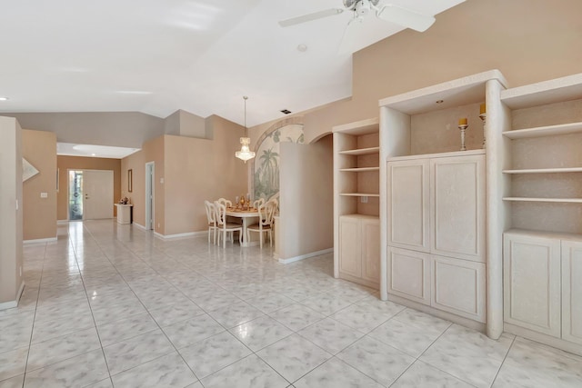 dining room featuring baseboards, ceiling fan, light tile patterned flooring, and vaulted ceiling