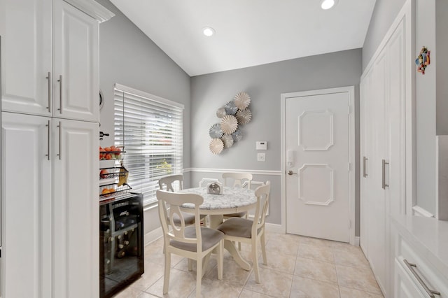 dining room with recessed lighting, baseboards, vaulted ceiling, and light tile patterned floors