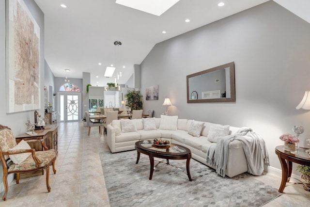 living area with a skylight, high vaulted ceiling, recessed lighting, and light tile patterned flooring