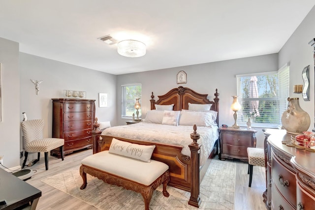 bedroom featuring visible vents and light wood-style floors
