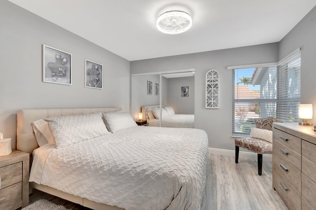 bedroom with baseboards and light wood-style flooring