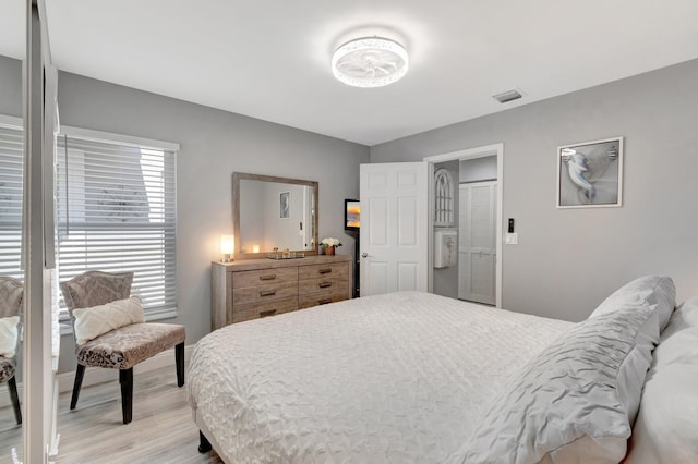 bedroom featuring light wood-style flooring and visible vents