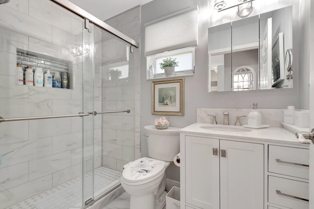 full bath with vanity, toilet, and a shower stall