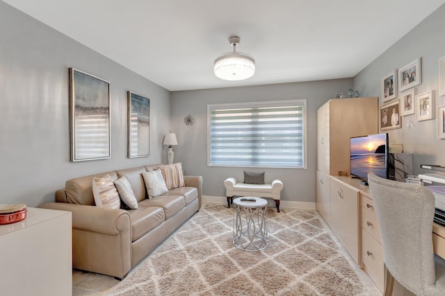 living area featuring baseboards