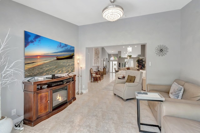 living area featuring baseboards and light tile patterned floors