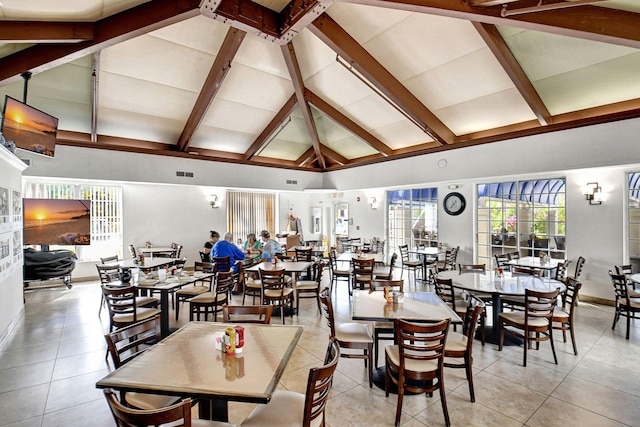 dining room with high vaulted ceiling, baseboards, beamed ceiling, and light tile patterned flooring