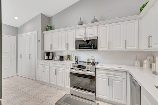 kitchen with light countertops, appliances with stainless steel finishes, white cabinets, and light tile patterned floors