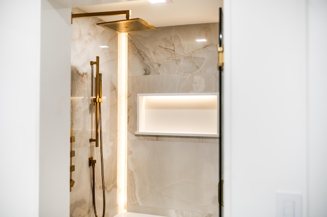 bathroom with a marble finish shower