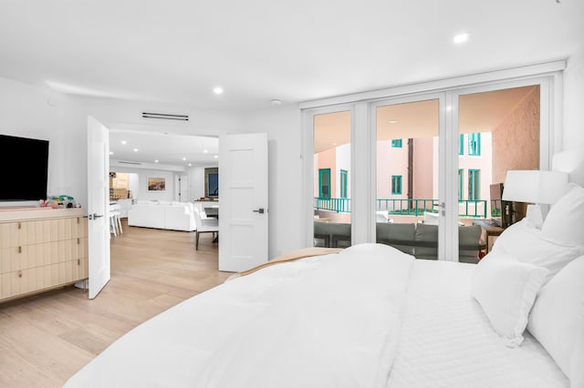 bedroom featuring expansive windows, visible vents, access to exterior, recessed lighting, and light wood finished floors