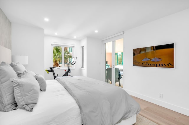 bedroom with baseboards, recessed lighting, and light wood-style flooring