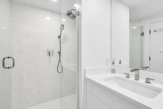 bathroom featuring vanity and a shower stall