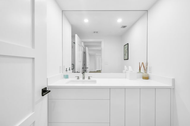 bathroom with recessed lighting, visible vents, and vanity