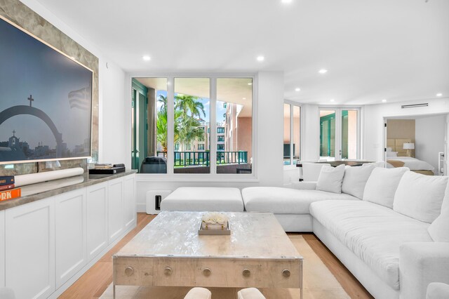 living area with light wood-style floors and recessed lighting