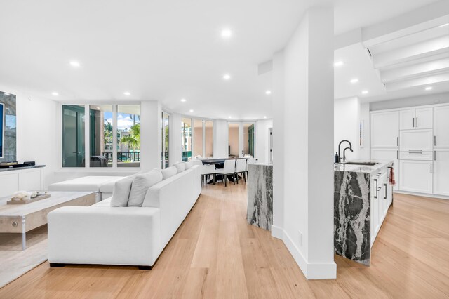 living area featuring light wood-style floors and recessed lighting