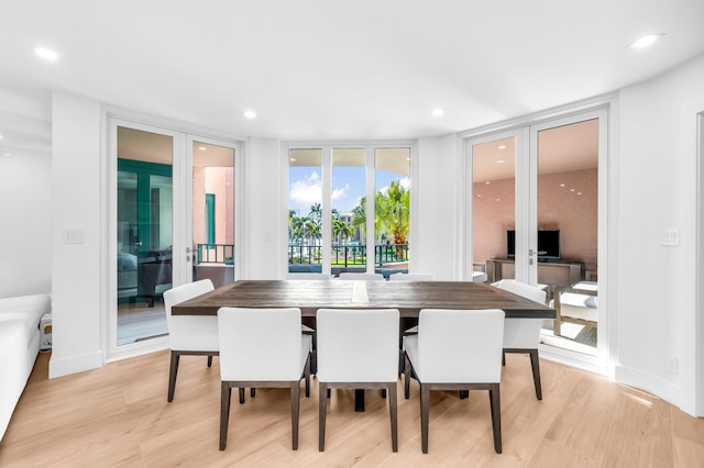 dining room with recessed lighting and light wood-style floors