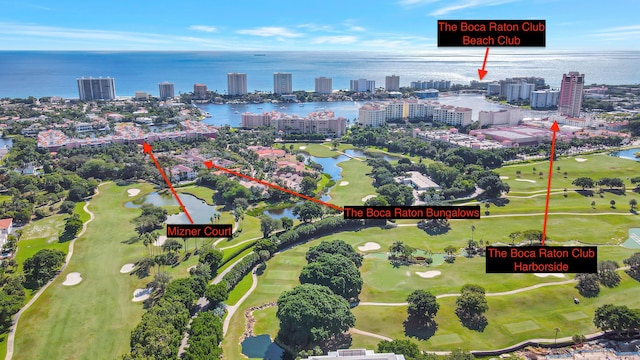 drone / aerial view with a view of city, a water view, and golf course view