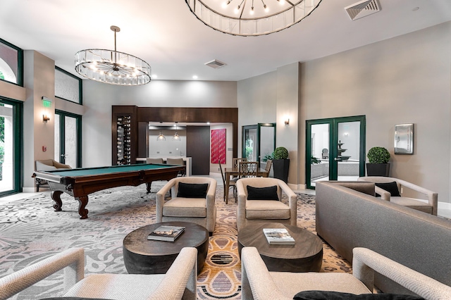 game room featuring visible vents, pool table, a chandelier, and a high ceiling