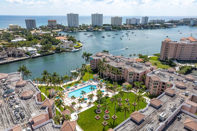 birds eye view of property with a water view and a city view