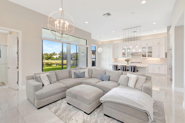 living area with an inviting chandelier, baseboards, recessed lighting, and visible vents