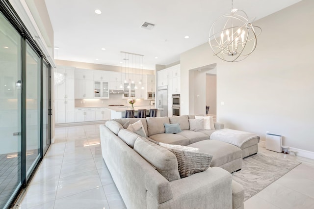 living area with visible vents, recessed lighting, and a chandelier