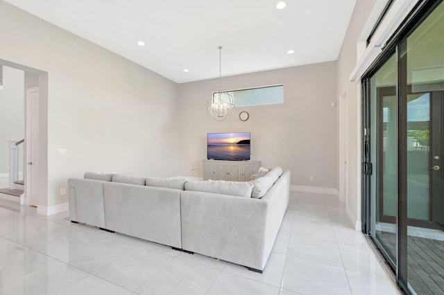 living area with light tile patterned floors, baseboards, recessed lighting, and a notable chandelier