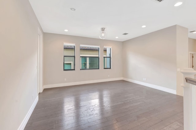 unfurnished living room with baseboards, wood-type flooring, recessed lighting, and visible vents