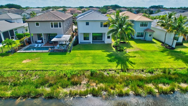 rear view of house with a lawn, a fenced backyard, stucco siding, and a residential view