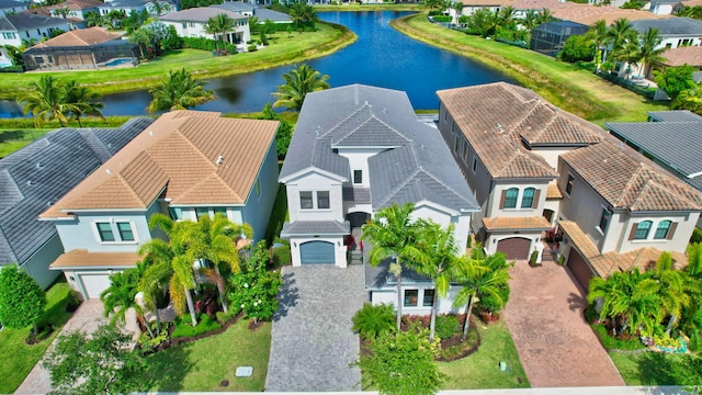 drone / aerial view featuring a residential view and a water view