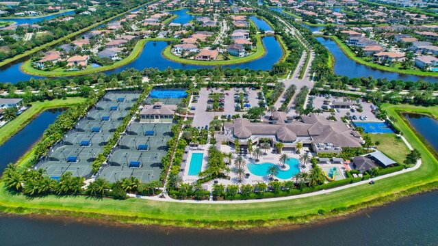 birds eye view of property with a water view and a residential view