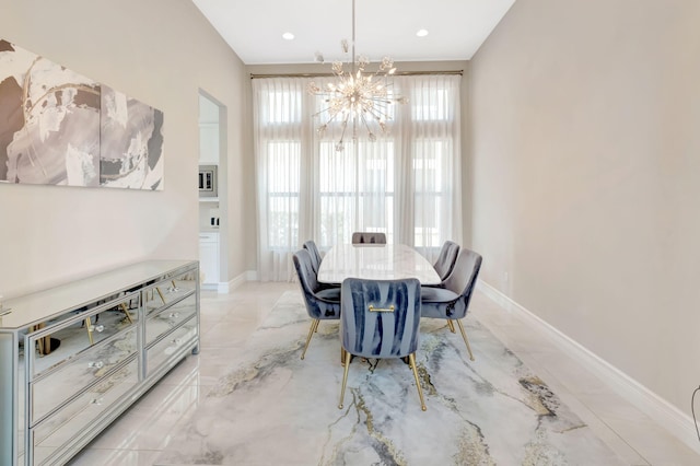 dining area featuring an inviting chandelier, baseboards, recessed lighting, and marble finish floor