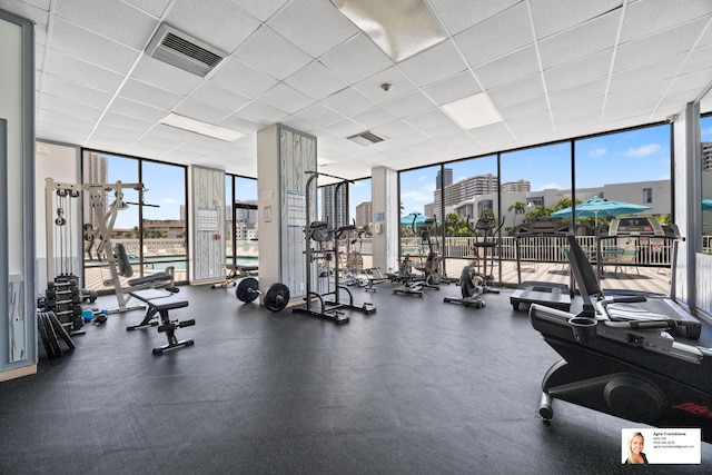 137 Golden Isles Dr Unit 806, Hallandale Beach, FL 33009 - workout area featuring a wall of windows, a city view, and a drop ceiling
