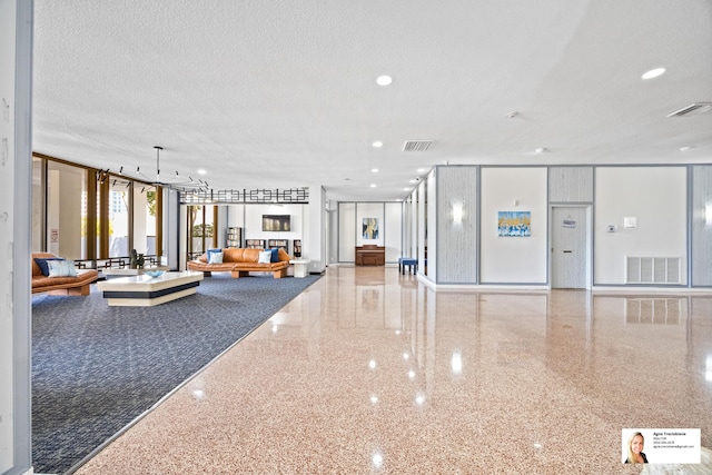 137 Golden Isles Dr Unit 806, Hallandale Beach, FL 33009 - lobby featuring a textured ceiling