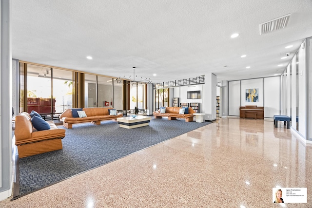 137 Golden Isles Dr Unit 806, Hallandale Beach, FL 33009 - lobby featuring a textured ceiling, expansive windows, and recessed lighting
