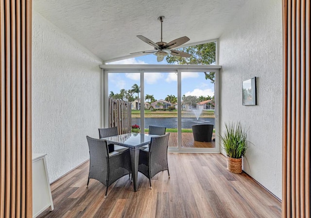 sunroom / solarium with a water view
