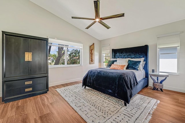 bedroom featuring baseboards, a ceiling fan, wood finished floors, and vaulted ceiling