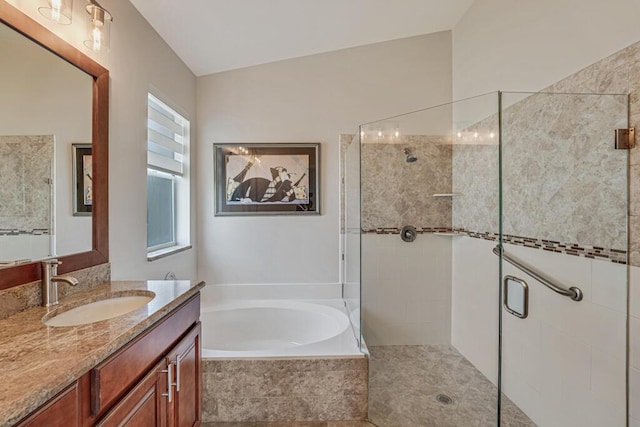 bathroom featuring vanity, a stall shower, and a bath