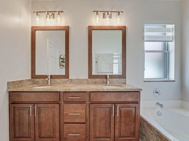 bathroom featuring double vanity, a sink, and a bath