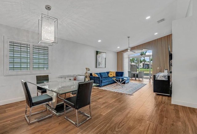 dining space with baseboards, ceiling fan, wood finished floors, and visible vents